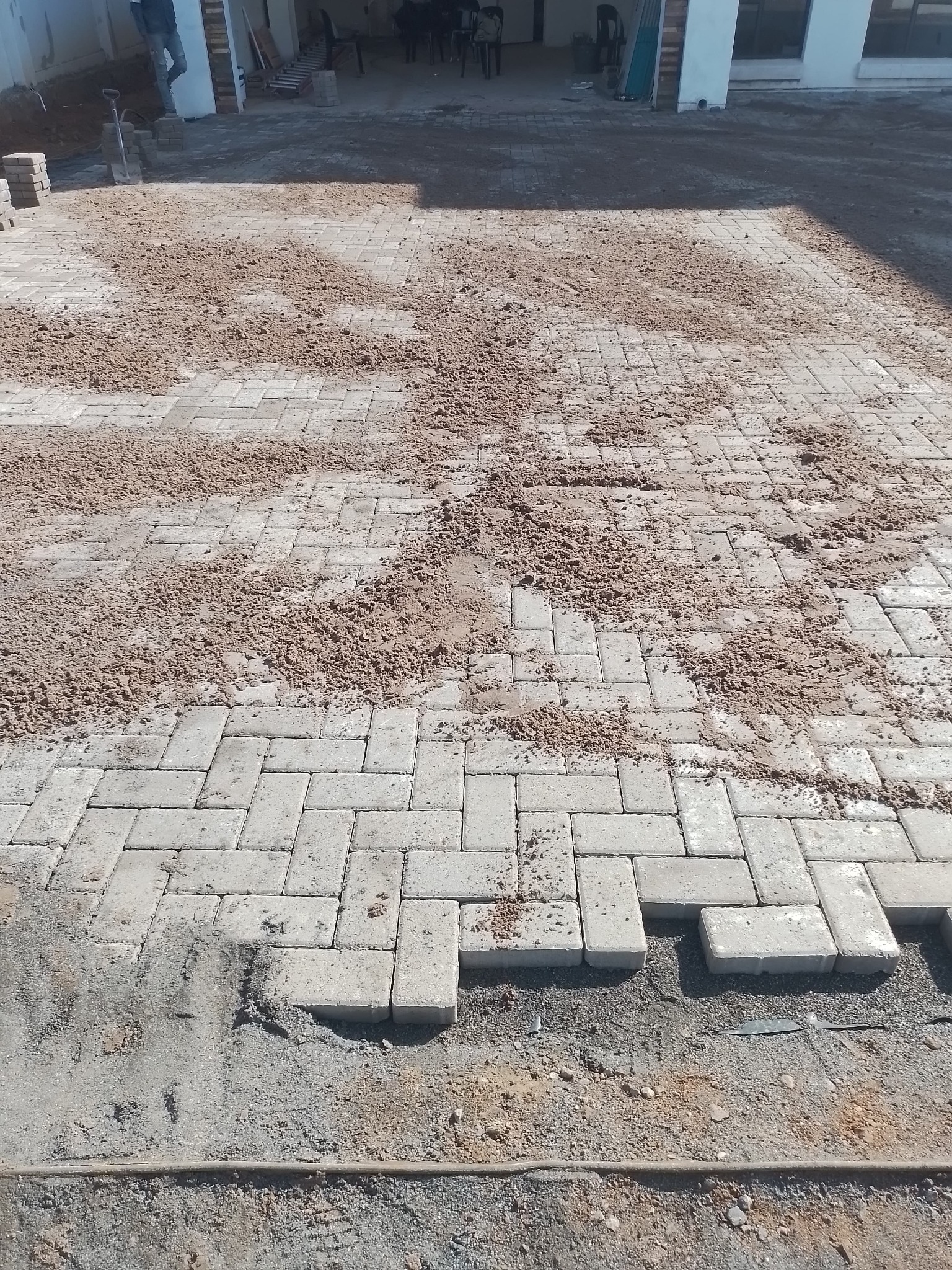 Sand finishing applied to a paved surface